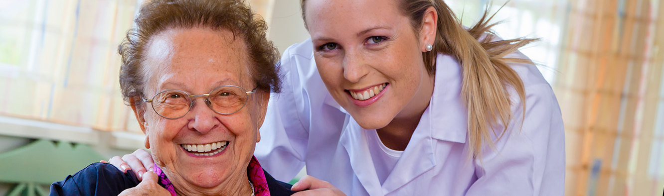 Eine examinierte Pflegerin versorgt eine Patientin in Iserlohn